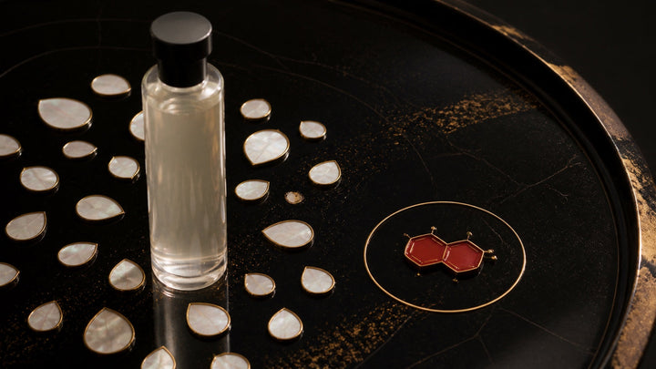 A gentle toner surrounded by pearl ingredient droplets with one vermilion Vitamin K3 tile under inspection