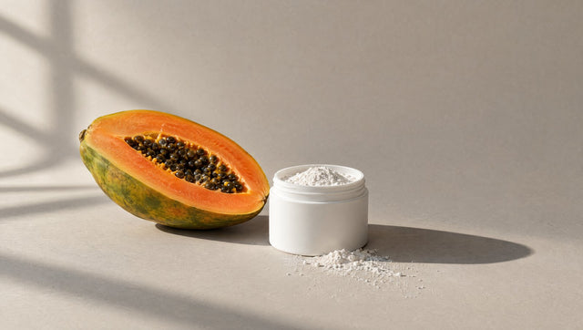 Halved papaya beside an open tub of fine white powder