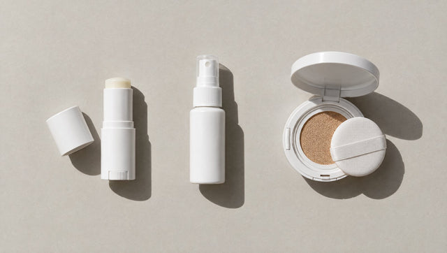 Sunscreen stick, small spray bottle and open cushion compact