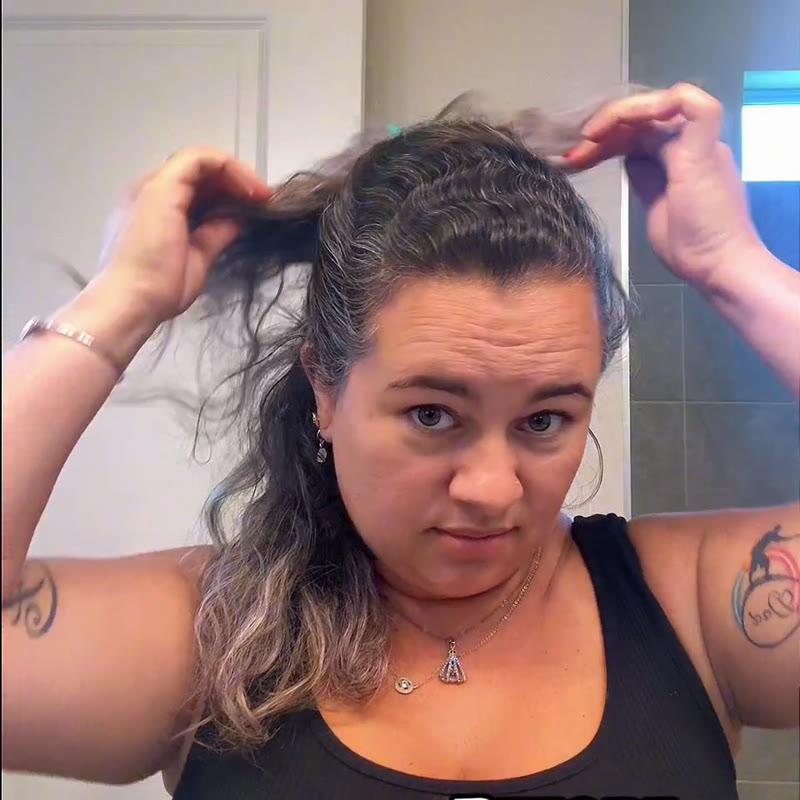 Customer lifting her hair to show grey at the temple, before use